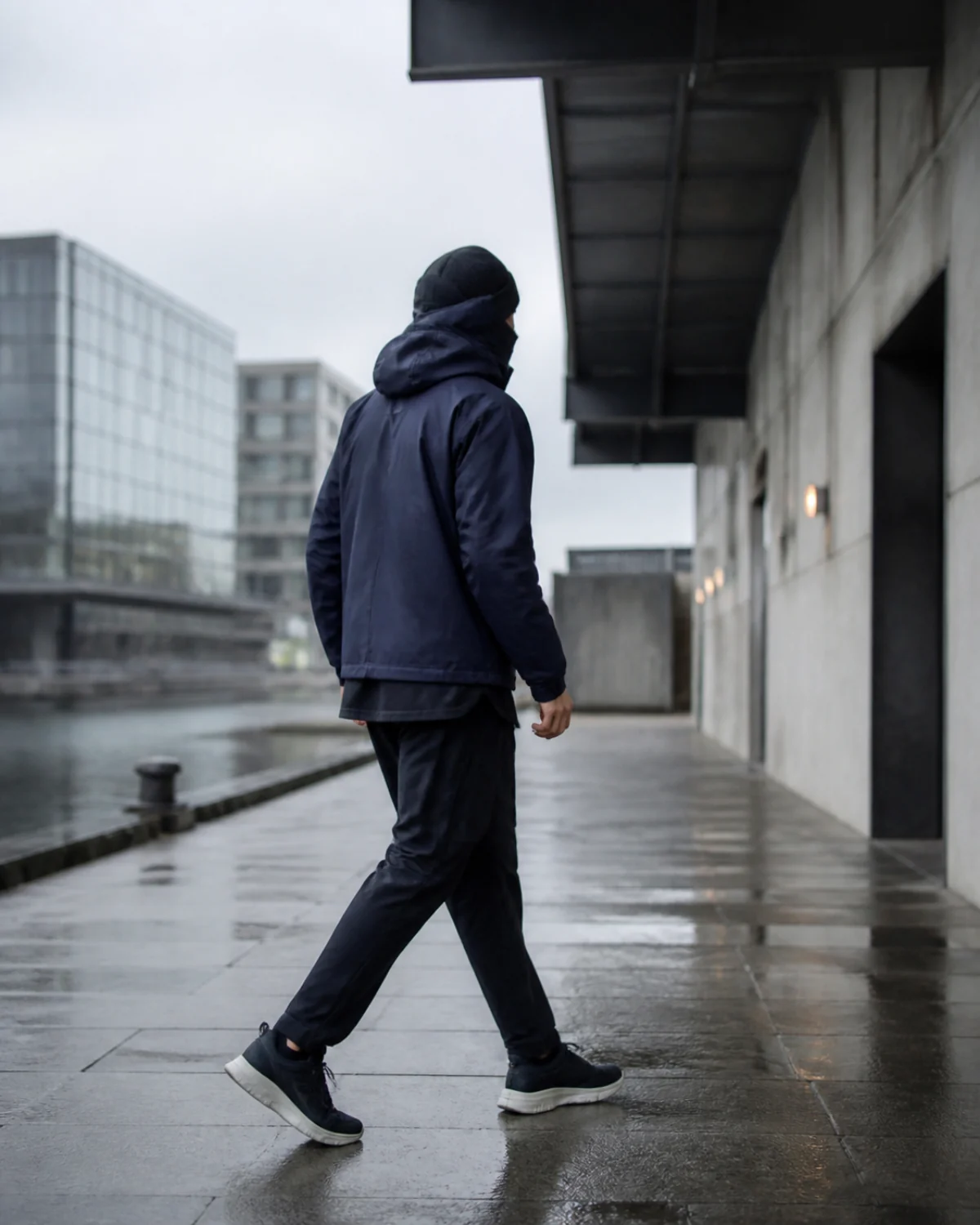 Performance apparel in motion beside restrained contemporary Amsterdam architecture